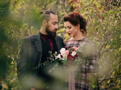 Wedding photographer and videographer team framing outdoor bride and groom portrait in Atlanta