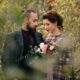 Wedding photographer and videographer team framing outdoor bride and groom portrait in Atlanta