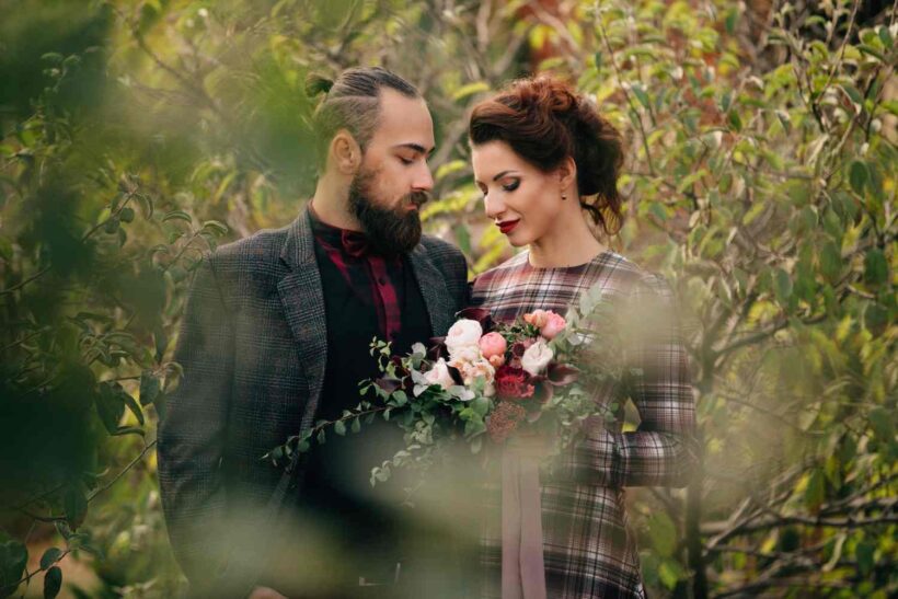 Wedding photographer and videographer team framing outdoor bride and groom portrait in Atlanta