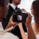 Professional videographer capturing ceremony vows for wedding videography deliverables